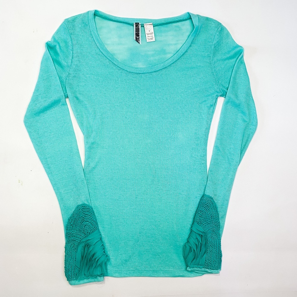 Light teal long sleeve waffle knit top, with detailed sleeves.